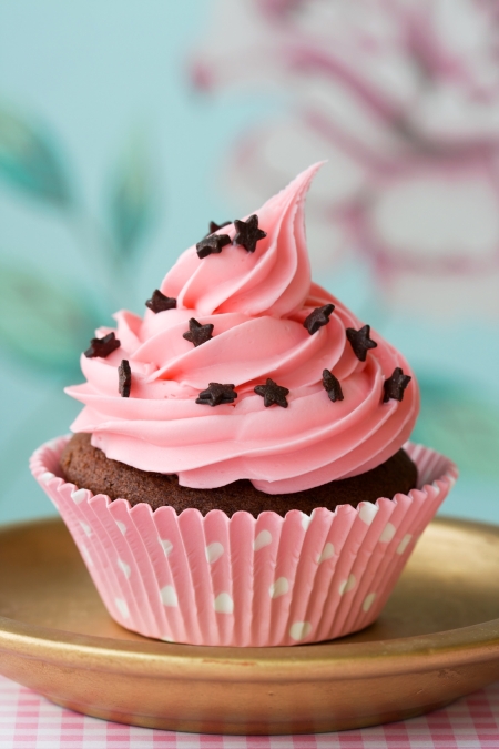 Pink cupcake decorated with chocolate stars
